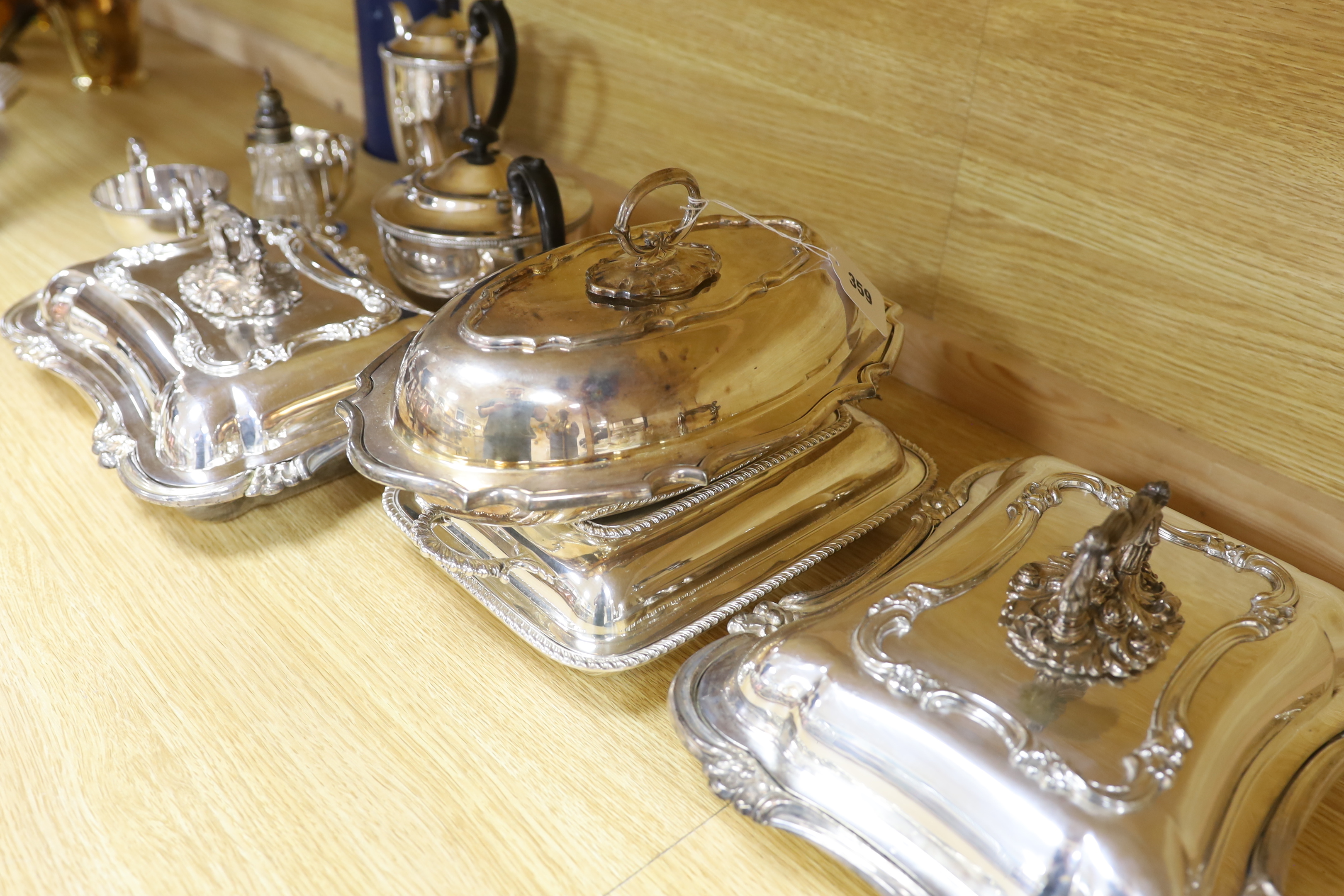 A quantity of silver plate including tea and coffee pots with ebonised handles and a pair of serving dishes